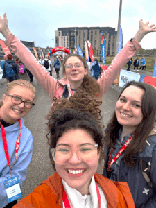 four smiling members of Global Connects staff on the Kiltwalk starting line