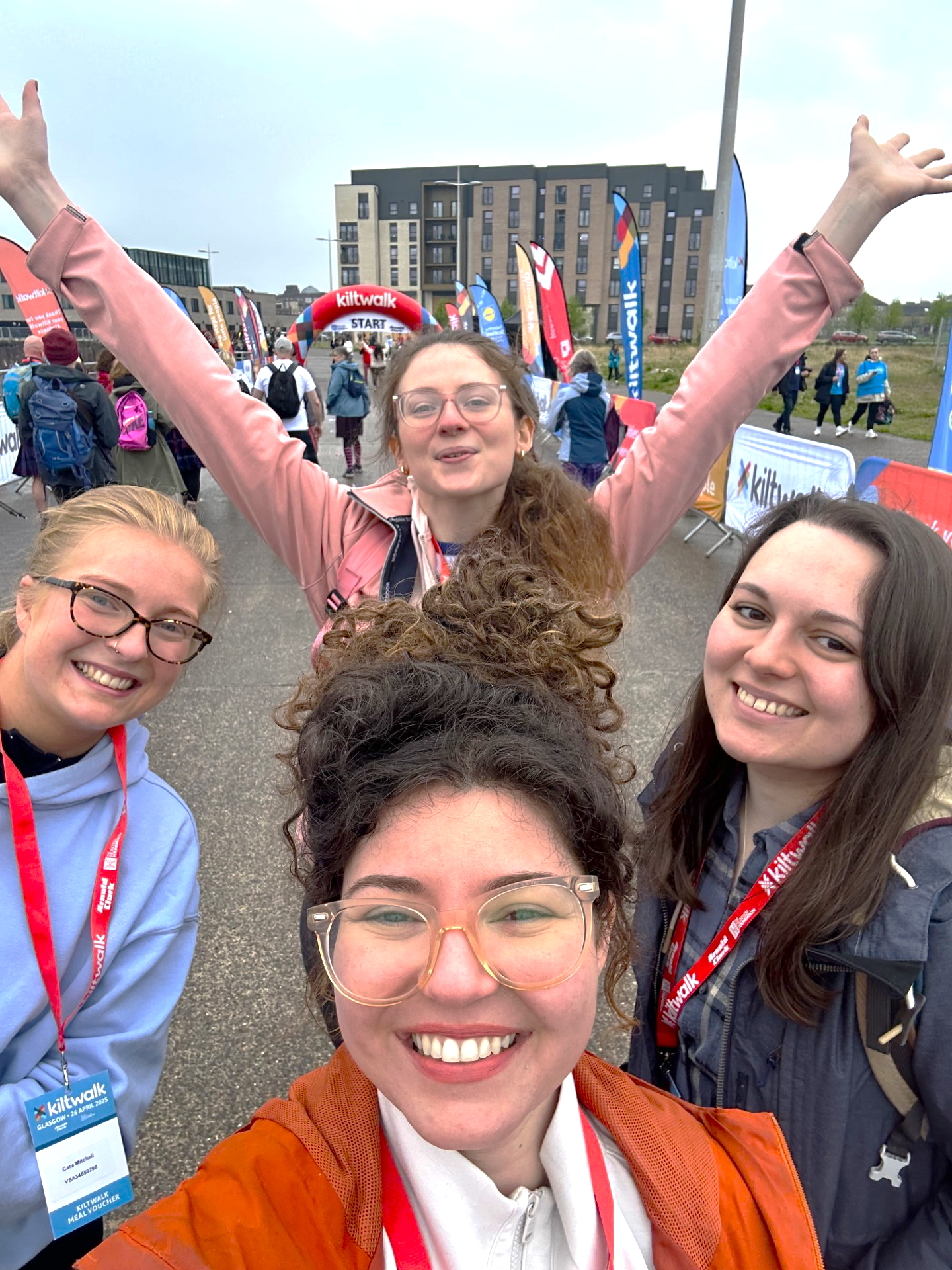 four smiling members of Global Connects staff on the Kiltwalk starting line